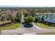 Community entrance with lush landscaping, mature trees and neighborhood signs at 252 Magneta Loop, Auburndale, FL 33823
