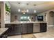 Modern kitchen featuring granite countertops and stainless steel appliances with pendant lights at 252 Magneta Loop, Auburndale, FL 33823