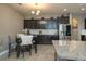 A modern kitchen with stainless steel appliances, dark cabinets, and granite countertops at 252 Magneta Loop, Auburndale, FL 33823