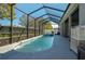 A beautiful covered pool with an attached spa in a screened-in enclosure at 252 Magneta Loop, Auburndale, FL 33823