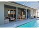 Covered patio area overlooking the pool with seating and dining at 252 Magneta Loop, Auburndale, FL 33823