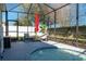 An outdoor patio with a screened-in pool, an umbrella, and outdoor seating at 252 Magneta Loop, Auburndale, FL 33823