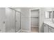 Bathroom with glass shower, white cabinets and granite counters. Includes access to a walk-in closet at 3146 Laurel Oak Ln, Winter Haven, FL 33884