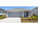 Charming single-story home featuring a gray exterior, well-manicured landscaping and a two-car garage at 3146 Laurel Oak Ln, Winter Haven, FL 33884