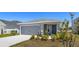 Single-story home with a gray exterior, two-car garage, and newly installed landscaping in the front yard at 3146 Laurel Oak Ln, Winter Haven, FL 33884