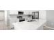 Modern kitchen with stainless steel appliances, white cabinetry and a large center island with sink at 3146 Laurel Oak Ln, Winter Haven, FL 33884