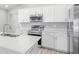 Bright kitchen features white cabinets, granite countertops and stainless steel appliances at 3146 Laurel Oak Ln, Winter Haven, FL 33884