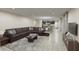 Spacious living room with large sectional sofa and hardwood floors at 3146 Laurel Oak Ln, Winter Haven, FL 33884