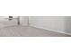 Open concept living room and kitchen area with bright walls and modern wood-look flooring at 3146 Laurel Oak Ln, Winter Haven, FL 33884