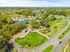 Aerial view of community features including golf course and tennis courts at 32334 Oak Park Dr, Leesburg, FL 34748