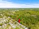Aerial view of a single-Gathering home with a surrounding community at 32334 Oak Park Dr, Leesburg, FL 34748