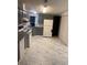 Renovated kitchen with gray cabinets, white appliances, and marble-look flooring at 32334 Oak Park Dr, Leesburg, FL 34748