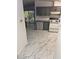 Gray cabinets and marble-look floors in this updated kitchen at 32334 Oak Park Dr, Leesburg, FL 34748