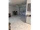 Spacious living area with marble-look flooring and sliding glass doors at 32334 Oak Park Dr, Leesburg, FL 34748