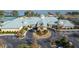 Community clubhouse with tennis courts and circular driveway at 3441 Grenville Dr, Winter Haven, FL 33884