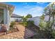 Backyard with brick-paved pathway, lemon tree and fence at 3441 Grenville Dr, Winter Haven, FL 33884