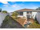 Backyard with patio furniture and a partially unkempt lawn at 3441 Grenville Dr, Winter Haven, FL 33884