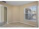 Dining area featuring tiled floors, beige walls, and large window with blinds at 3441 Grenville Dr, Winter Haven, FL 33884
