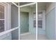 Front entrance with green door and a screened porch at 3441 Grenville Dr, Winter Haven, FL 33884