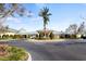 Community clubhouse with a manicured circular driveway and lush landscaping at 3441 Grenville Dr, Winter Haven, FL 33884