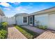 Side view of the house with a walkway and green landscaping at 3441 Grenville Dr, Winter Haven, FL 33884