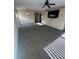 Open-concept living room with plush carpeting, ceiling fan, and mounted TV at 3441 Grenville Dr, Winter Haven, FL 33884
