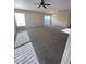 Large living room with neutral carpet, ceiling fan, and natural light from multiple windows at 3441 Grenville Dr, Winter Haven, FL 33884