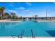 Community pool with blue water and views of the lake at 3441 Grenville Dr, Winter Haven, FL 33884