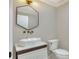 Modern bathroom with hexagon mirror and white pedestal sink at 3960 Laurel Se Ave, Lakeland, FL 33812