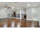 Spacious bonus room with dark hardwood floors and modern metal railing at 3960 Laurel Se Ave, Lakeland, FL 33812