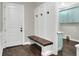 Inviting entryway with built-in bench and coat hooks, leading to laundry room at 3960 Laurel Se Ave, Lakeland, FL 33812