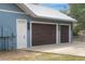 Two-car garage with dark brown doors and exterior lights at 3960 Laurel Se Ave, Lakeland, FL 33812