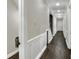 Long hallway with dark hardwood floors and white wainscoting at 3960 Laurel Se Ave, Lakeland, FL 33812