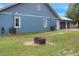 Side view showcasing the house's exterior, garage, and fire pit at 3960 Laurel Se Ave, Lakeland, FL 33812