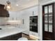Modern kitchen with white cabinets, quartz countertops, and stainless steel appliances at 3960 Laurel Se Ave, Lakeland, FL 33812