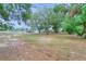 Open land with mature trees and a partial fence at 3960 Laurel Se Ave, Lakeland, FL 33812