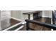 Dark hardwood stairs with white risers and a black metal railing at 3960 Laurel Se Ave, Lakeland, FL 33812