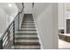 Elegant staircase with dark wood steps and a modern metal railing at 3960 Laurel Se Ave, Lakeland, FL 33812