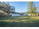 Spacious backyard with home view and large trees at 410 N Tecumseh Ave, Fort Meade, FL 33841