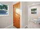 Updated bathroom with a toilet, shower, and window at 410 N Tecumseh Ave, Fort Meade, FL 33841
