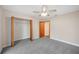 Well-lit bedroom with a large closet and door to hallway at 410 N Tecumseh Ave, Fort Meade, FL 33841