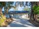 Two-car garage with driveway and mature trees at 410 N Tecumseh Ave, Fort Meade, FL 33841