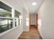 Bright hallway with wood-look flooring and large window at 410 N Tecumseh Ave, Fort Meade, FL 33841