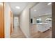 Long hallway with light walls and wood-look flooring, leading to other rooms at 410 N Tecumseh Ave, Fort Meade, FL 33841