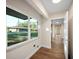 Hallway with window, wood-look floors and doors to other rooms at 410 N Tecumseh Ave, Fort Meade, FL 33841