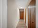 Hallway with wood-look flooring and access to bedrooms at 410 N Tecumseh Ave, Fort Meade, FL 33841