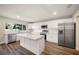 Modern kitchen featuring white cabinets, stainless steel appliances, and a large island at 410 N Tecumseh Ave, Fort Meade, FL 33841