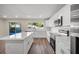 Bright kitchen boasts white cabinets, stainless steel appliances, and an island at 410 N Tecumseh Ave, Fort Meade, FL 33841