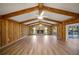 Spacious living room with a stone fireplace and wood beams at 410 N Tecumseh Ave, Fort Meade, FL 33841