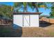 White shed in a sunny backyard setting at 410 N Tecumseh Ave, Fort Meade, FL 33841